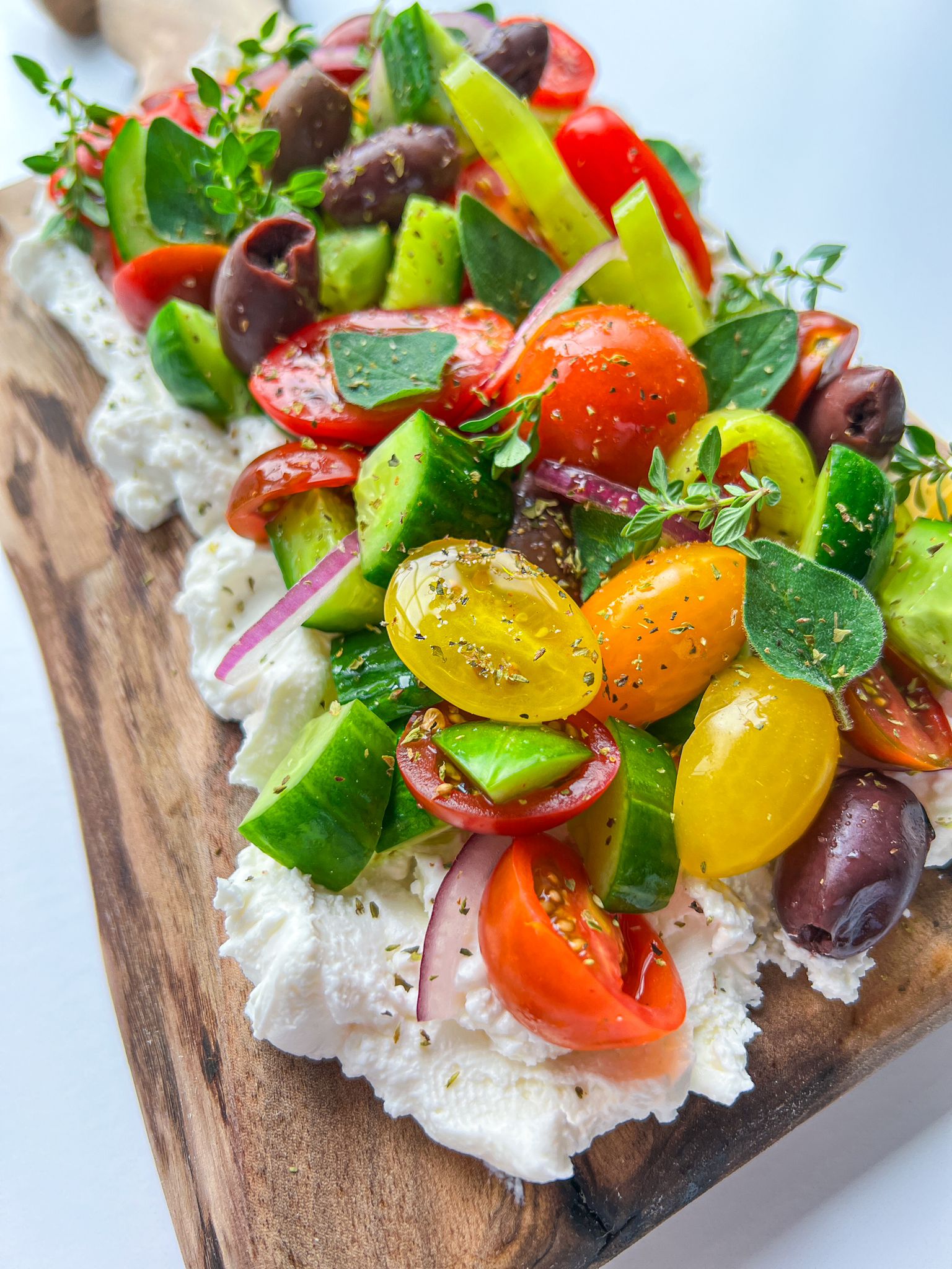 Colourful Greek Salad Feta Board with whipped feta, cherry tomatoes, cucumber, olives & herbs – a fresh Mediterranean appetizer board. - 3