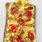 A wooden board topped with swirls of butter, fresh fig slices, crushed nuts, herbs, and honey drizzles—discover how to make a butter board that's perfect as an appetizer or elegant spread for any occasion.