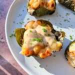 Close-up of Shrimp Sushi Cups baked to perfection, topped with a creamy sauce and sprinkled with chopped herbs, served on a white plate.