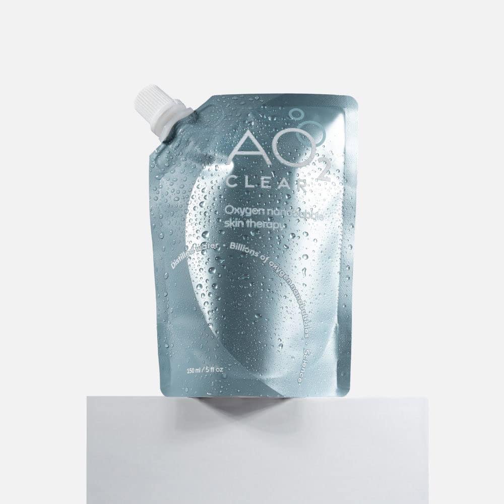 A light blue, resealable pouch labeled "AO Clear Oxygen Nanobubble Skin Therapy," featuring condensation droplets on its surface, stands upright against a plain white backgroundโperfect for those seeking exclusive deals on premium skincare.
