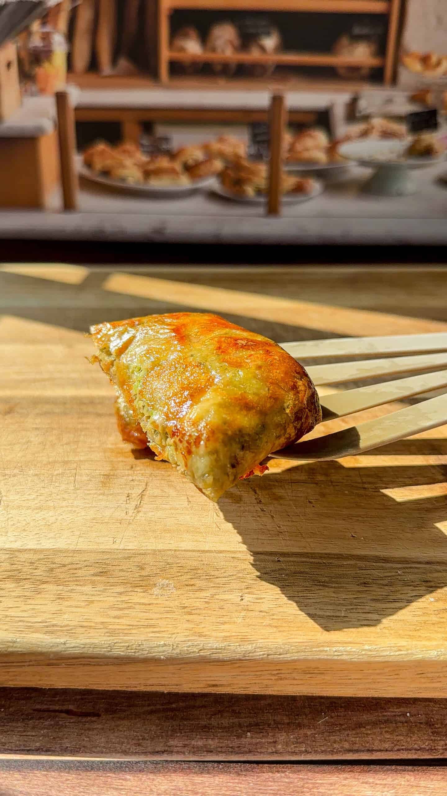 a person showing the inside of a crispy Rice Paper Tunacado melt
