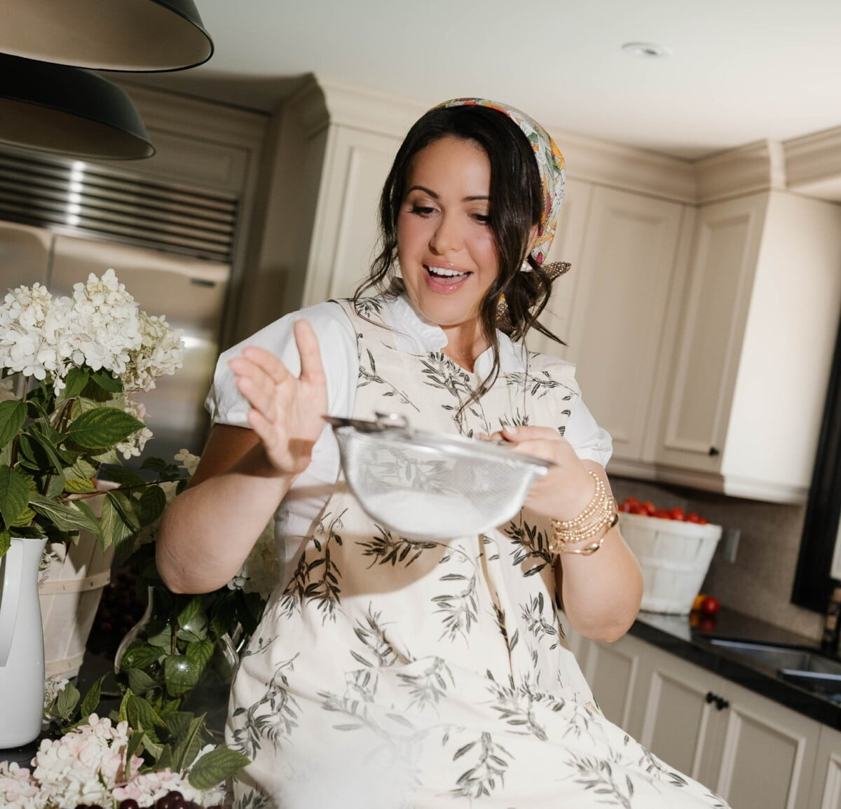 Snejana Andreeva sifting flour in her kitchen.