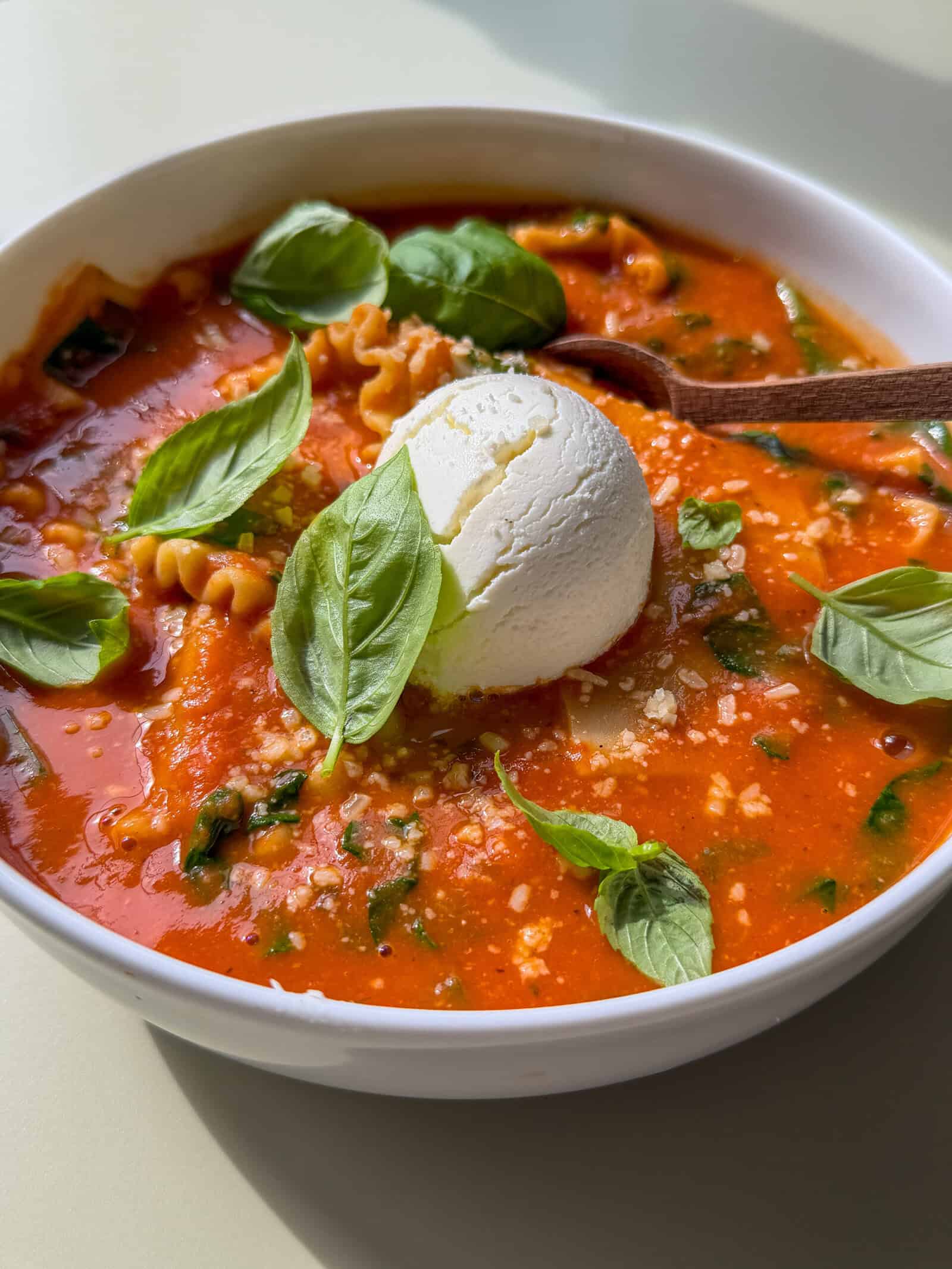 High fibre lasagna soup in a bowl with a dollop of ricotta on top