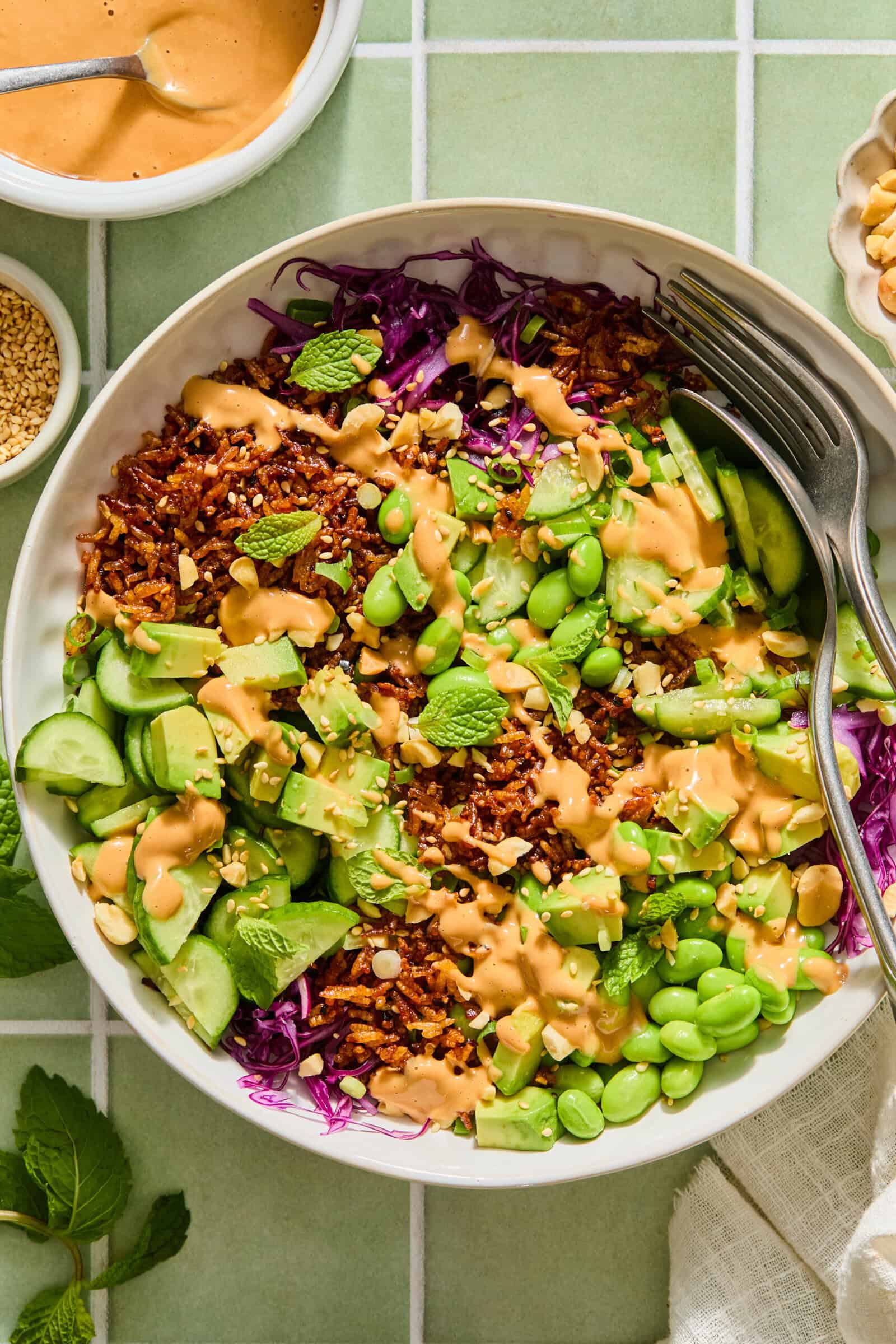 Vibrant rice bowl with peanut sauce, edamame, and avocado