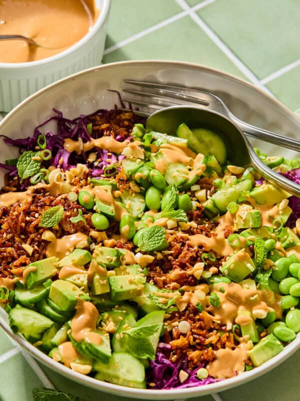 Vibrant rice bowl with avocado, edamame, and peanut sauce
