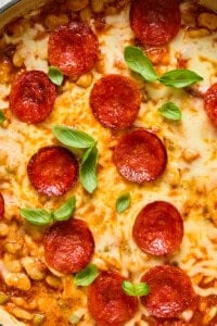 Skillet pepperoni pizza dip with melted cheese and basil