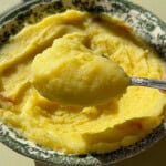 Creamy mashed potatoes in decorative green floral bowl