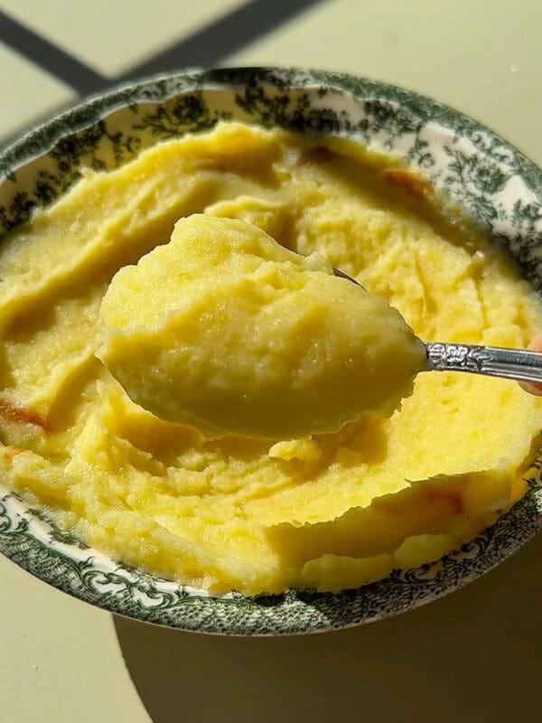 Creamy mashed potatoes in decorative green floral bowl